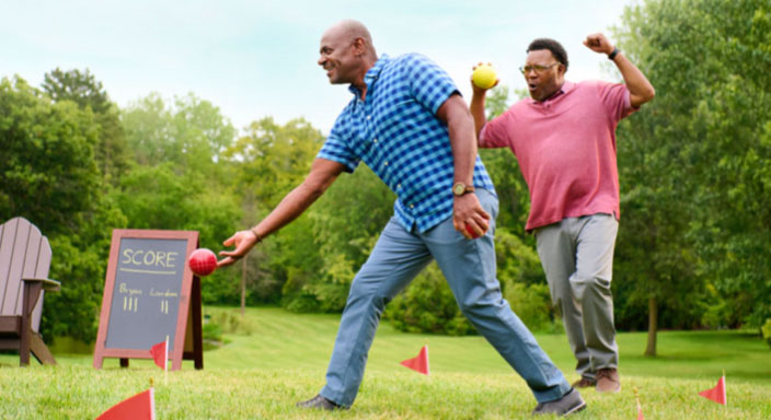 Image of Bryan and his brother playing bocce ball