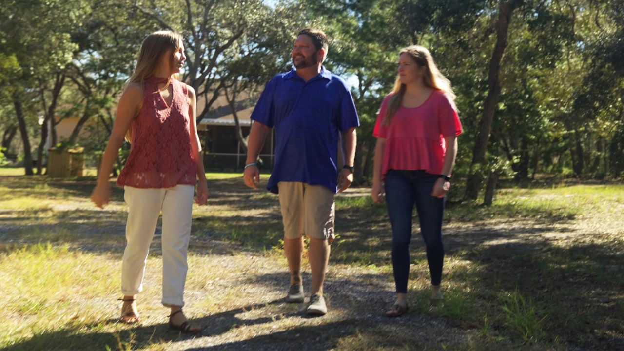 A group of people walking outside A group of people walking outside